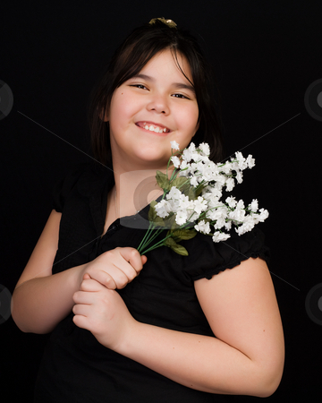 To use this stock image in your creative project, please select the size you need over to the right and click the "Add to Cart" button.
Your downloaded image will come with the Cutcaster watermark removed so don’t worry about the watermark you see on this page. Childhood Portrait stock photo, A young girl holding some silk flowers, shot against a black background by Richard Nelson