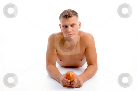 To use this stock image in your creative project, please select the size you need over to the right and click the "Add to Cart" button.
Your downloaded image will come with the Cutcaster watermark removed so don’t worry about the watermark you see on this page. Laying fit man with apple stock photo, Laying fit man with apple against white background by Imagery Majestic