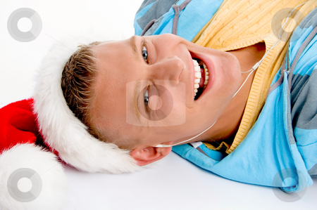 To use this stock image in your creative project, please select the size you need over to the right and click the "Add to Cart" button.
Your downloaded image will come with the Cutcaster watermark removed so don’t worry about the watermark you see on this page. Smiling young man with christmas hat stock photo, Smiling young man with christmas hat against white background by Imagery Majestic