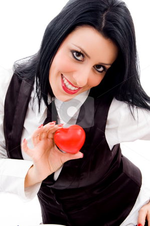 To use this stock image in your creative project, please select the size you need over to the right and click the "Add to Cart" button.
Your downloaded image will come with the Cutcaster watermark removed so don’t worry about the watermark you see on this page. Woman smiling and holding a small red heart stock photo, Woman smiling and holding a small red heart against white background by Imagery Majestic