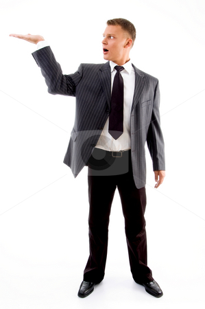 To use this stock image in your creative project, please select the size you need over to the right and click the "Add to Cart" button.
Your downloaded image will come with the Cutcaster watermark removed so don’t worry about the watermark you see on this page. Standing adult handsome man with open palm stock photo, Standing adult handsome man with open palm against white background by Imagery Majestic