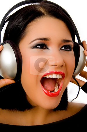 To use this stock image in your creative project, please select the size you need over to the right and click the "Add to Cart" button.
Your downloaded image will come with the Cutcaster watermark removed so don’t worry about the watermark you see on this page. Portrait of happy beautiful female listening music stock photo, Portrait of happy beautiful female listening music on an isolated background by Imagery Majestic