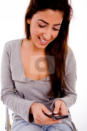 To use this stock image in your creative project, please select the size you need over to the right and click the "Add to Cart" button.
Your downloaded image will come with the Cutcaster watermark removed so don’t worry about the watermark you see on this page. Woman calling on mobile phone stock photo, Front view of smiling woman looking the mobile against white background by Imagery Majestic