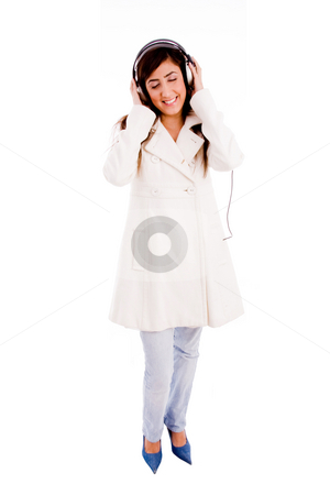 To use this stock image in your creative project, please select the size you need over to the right and click the "Add to Cart" button.
Your downloaded image will come with the Cutcaster watermark removed so don’t worry about the watermark you see on this page. Front view of young woman enjoying music stock photo, Front view of young woman enjoying music with white background by Imagery Majestic