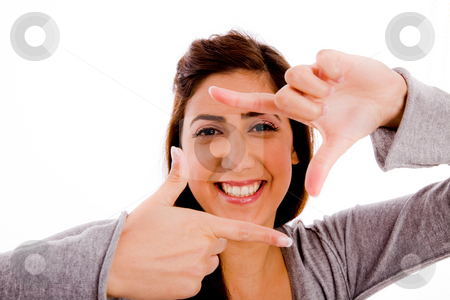 To use this stock image in your creative project, please select the size you need over to the right and click the "Add to Cart" button.
Your downloaded image will come with the Cutcaster watermark removed so don’t worry about the watermark you see on this page. Woman making frame with hands stock photo, Portrait of smiling woman showing framing gesture against white background by Imagery Majestic