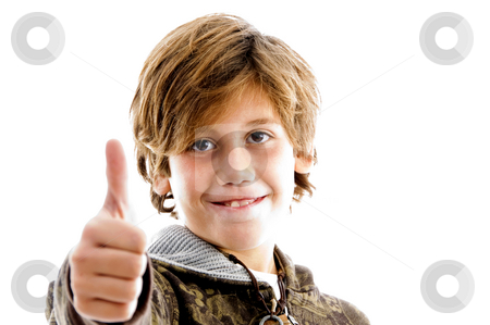 To use this stock image in your creative project, please select the size you need over to the right and click the "Add to Cart" button.
Your downloaded image will come with the Cutcaster watermark removed so don’t worry about the watermark you see on this page. Front view of pleased kid with thumbs up stock photo, Front view of pleased kid with thumbs up with white background by Imagery Majestic