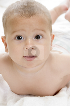 To use this stock image in your creative project, please select the size you need over to the right and click the "Add to Cart" button.
Your downloaded image will come with the Cutcaster watermark removed so don’t worry about the watermark you see on this page. Happy child lying and looking at camera stock photo, Happy child lying and looking at camera on an isolated white background by Imagery Majestic