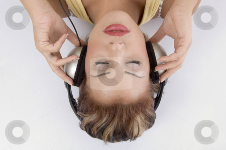 To use this stock image in your creative project, please select the size you need over to the right and click the "Add to Cart" button.
Your downloaded image will come with the Cutcaster watermark removed so don’t worry about the watermark you see on this page. Laying woman with headphone stock photo, Laying woman with headphone against white background by Imagery Majestic