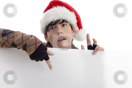 To use this stock image in your creative project, please select the size you need over to the right and click the "Add to Cart" button.
Your downloaded image will come with the Cutcaster watermark removed so don’t worry about the watermark you see on this page. Young boy wearing christmas hat indicating placard stock photo, Young boy wearing christmas hat indicating placard with white background by Imagery Majestic