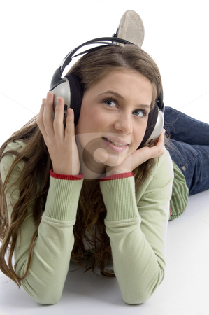 To use this stock image in your creative project, please select the size you need over to the right and click the "Add to Cart" button.
Your downloaded image will come with the Cutcaster watermark removed so don’t worry about the watermark you see on this page. Woman listening to music lying down stock photo, Woman listening to music lying down with white background by Imagery Majestic