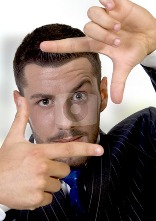 To use this stock image in your creative project, please select the size you need over to the right and click the "Add to Cart" button.
Your downloaded image will come with the Cutcaster watermark removed so don’t worry about the watermark you see on this page. Young businessman making a finger frame stock photo, Young businessman making a finger frame on an abstract background by Imagery Majestic