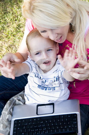 To use this stock image in your creative project, please select the size you need over to the right and click the "Add to Cart" button.
Your downloaded image will come with the Cutcaster watermark removed so don’t worry about the watermark you see on this page. Caring mother with laptop and her child stock photo, Caring mother with laptop and her child sitting in her lap by Imagery Majestic