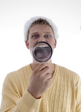 To use this stock image in your creative project, please select the size you need over to the right and click the "Add to Cart" button.
Your downloaded image will come with the Cutcaster watermark removed so don’t worry about the watermark you see on this page. Man weaing santa hat and showing teeth through lens stock photo, Man weaing santa hat and showing teeth through lens on an isolated background by Imagery Majestic