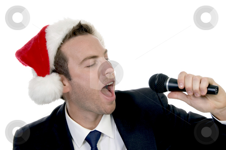 To use this stock image in your creative project, please select the size you need over to the right and click the "Add to Cart" button.
Your downloaded image will come with the Cutcaster watermark removed so don’t worry about the watermark you see on this page. Young man singing into microphone with santa cap stock photo, Young man singing into microphone with santa cap on an isolated background by Imagery Majestic