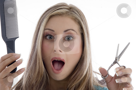 To use this stock image in your creative project, please select the size you need over to the right and click the "Add to Cart" button.
Your downloaded image will come with the Cutcaster watermark removed so don’t worry about the watermark you see on this page. Surprised woman holding scissor and comb stock photo, Surprised woman holding scissor and comb on an isolated background by Imagery Majestic