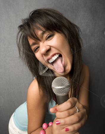To use this stock image in your creative project, please select the size you need over to the right and click the "Add to Cart" button.
Your downloaded image will come with the Cutcaster watermark removed so don’t worry about the watermark you see on this page. Beautiful Young Singer Sticking Out Her Tongue stock photo, Pretty young singer with a large microphone by Scott Griessel