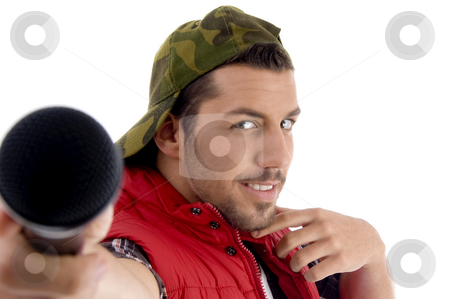To use this stock image in your creative project, please select the size you need over to the right and click the "Add to Cart" button.
Your downloaded image will come with the Cutcaster watermark removed so don’t worry about the watermark you see on this page. Young caucasian offering his microphone stock photo, Young caucasian offering his microphone with white background by Imagery Majestic
