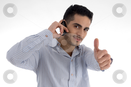 To use this stock image in your creative project, please select the size you need over to the right and click the "Add to Cart" button.
Your downloaded image will come with the Cutcaster watermark removed so don’t worry about the watermark you see on this page. Man talking on cell phone and wishing goodluck stock photo, Man talking on cell phone and wishing goodluck on an isolated white background by Imagery Majestic