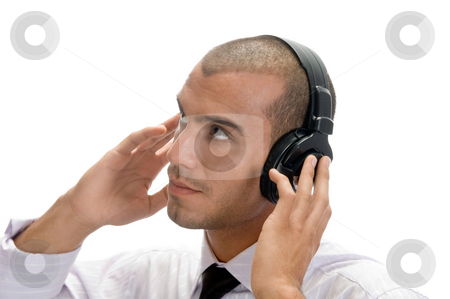 To use this stock image in your creative project, please select the size you need over to the right and click the "Add to Cart" button.
Your downloaded image will come with the Cutcaster watermark removed so don’t worry about the watermark you see on this page. Man holding earphone and looking upward stock photo, Man holding earphone and looking upward on an isolated background by Imagery Majestic