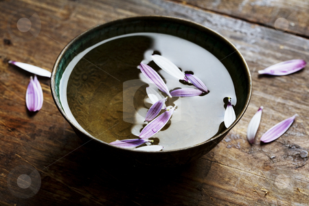 To use this stock image in your creative project, please select the size you need over to the right and click the "Add to Cart" button.
Your downloaded image will come with the Cutcaster watermark removed so don’t worry about the watermark you see on this page. Rustic bowl with petals stock photo, Old metal bowl with water and flower petals by Liv Friis-Larsen