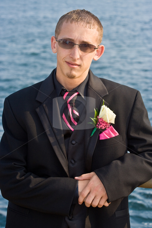 To use this stock image in your creative project, please select the size you need over to the right and click the "Add to Cart" button.
Your downloaded image will come with the Cutcaster watermark removed so don’t worry about the watermark you see on this page. Teenager in a Tuxedo stock photo, Portrait of a teenage boy in a tuxedo. Background is a blue ocean. The teen is dressed for a high school prom but the photo could be used to represent any formal occasion. by Stephen Bonk