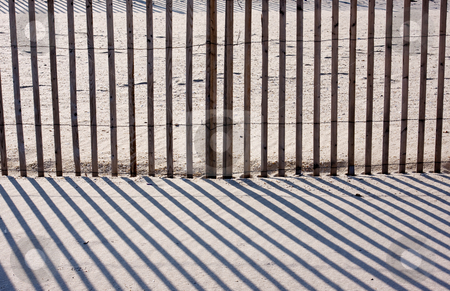 To use this stock image in your creative project, please select the size you need over to the right and click the "Add to Cart" button.
Your downloaded image will come with the Cutcaster watermark removed so don’t worry about the watermark you see on this page. Fence, Sand, and Shadows stock photo, An abstract image of a fence on a beach with diagnol shadows by Stephen Bonk