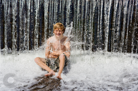 To use this stock image in your creative project, please select the size you need over to the right and click the "Add to Cart" button.
Your downloaded image will come with the Cutcaster watermark removed so don’t worry about the watermark you see on this page. Boy in Waterfall stock photo, A boy sitting under a waterfall getting splashed by the water by Stephen Bonk