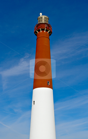 To use this stock image in your creative project, please select the size you need over to the right and click the "Add to Cart" button.
Your downloaded image will come with the Cutcaster watermark removed so don’t worry about the watermark you see on this page. Lighthouse stock photo, A red and white lighthouse against a blue sky. by Stephen Bonk