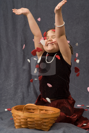 To use this stock image in your creative project, please select the size you need over to the right and click the "Add to Cart" button.
Your downloaded image will come with the Cutcaster watermark removed so don’t worry about the watermark you see on this page. Child Throwing Confetti stock photo, A young girl sitting on the floor and throwing heart shaped confetti into the air by Richard Nelson