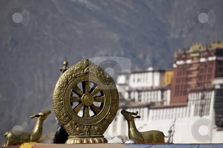 To use this stock image in your creative project, please select the size you need over to the right and click the "Add to Cart" button.
Your downloaded image will come with the Cutcaster watermark removed so don’t worry about the watermark you see on this page. Wheel of life stock photo, Tibetan golden statue with Potala Palace and mountains in the background by Marius Blajut