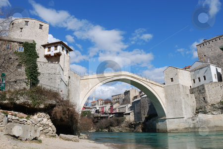 To use this stock image in your creative project, please select the size you need over to the right and click the "Add to Cart" button.
Your downloaded image will come with the Cutcaster watermark removed so don’t worry about the watermark you see on this page. Old Bridge in Mostar stock photo, Old Bridge in Mostar, Bosnia and Herzegovina with the old town and blue sky in background by Denis Radovanovic