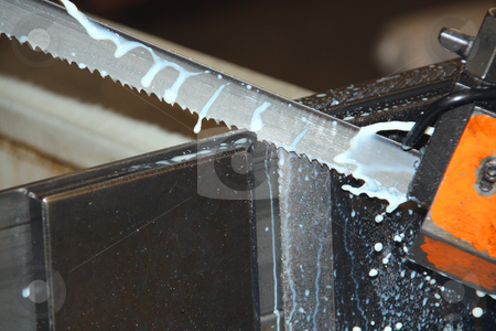 To use this stock image in your creative project, please select the size you need over to the right and click the "Add to Cart" button.
Your downloaded image will come with the Cutcaster watermark removed so don’t worry about the watermark you see on this page. Action shot showing blade and coolant of an industrial bandsaw stock photo, Action shot showing blade and coolant of an industrial bandsaw, frozen in time by Chris Alleaume