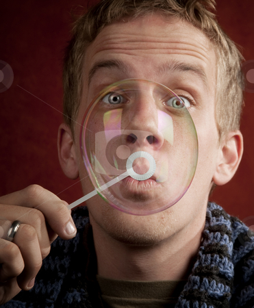 To use this stock image in your creative project, please select the size you need over to the right and click the "Add to Cart" button.
Your downloaded image will come with the Cutcaster watermark removed so don’t worry about the watermark you see on this page. Young Man Blowing a Bubble stock photo, Handsome young blonde man blowing a bubble by Scott Griessel