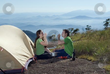 To use this stock image in your creative project, please select the size you need over to the right and click the "Add to Cart" button.
Your downloaded image will come with the Cutcaster watermark removed so don’t worry about the watermark you see on this page. Couple Drinking Wine Outdoors stock photo, Young, attractive couple enjoying a glass of wine while camping outdoors by Orange Line Media