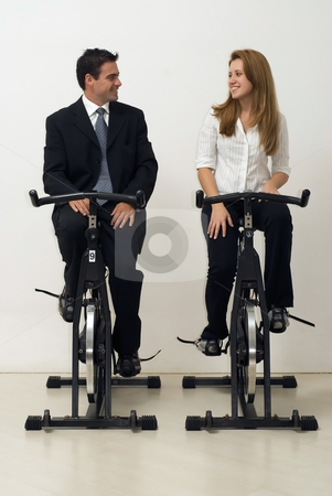 To use this stock image in your creative project, please select the size you need over to the right and click the "Add to Cart" button.
Your downloaded image will come with the Cutcaster watermark removed so don’t worry about the watermark you see on this page. Business Team on Exercise Bikes - Vertical stock photo, Male and female business colleagues looking at each other while riding exercise bikes. Vertically framed - isolated shot. by Orange Line Media