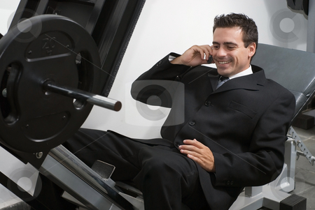 To use this stock image in your creative project, please select the size you need over to the right and click the "Add to Cart" button.
Your downloaded image will come with the Cutcaster watermark removed so don’t worry about the watermark you see on this page. Taking a Call in the Gym stock photo, Businessman on leg press machine taking a call. by Orange Line Media