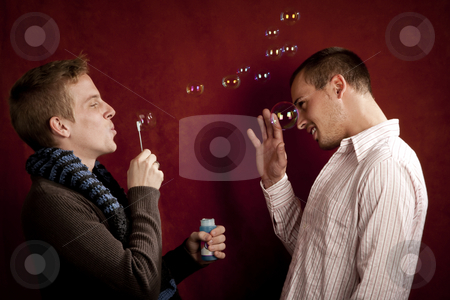 To use this stock image in your creative project, please select the size you need over to the right and click the "Add to Cart" button.
Your downloaded image will come with the Cutcaster watermark removed so don’t worry about the watermark you see on this page. Young Man Blowing a Bubbles at Friend stock photo, Handsome young blonde man blowing a bubbles at friends by Scott Griessel