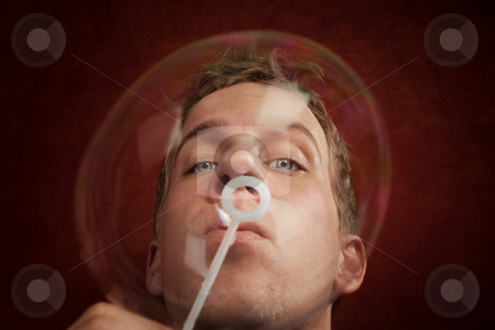 To use this stock image in your creative project, please select the size you need over to the right and click the "Add to Cart" button.
Your downloaded image will come with the Cutcaster watermark removed so don’t worry about the watermark you see on this page. Young Man Blowing a Bubble stock photo, Handsome young blonde man blowing a bubble by Scott Griessel