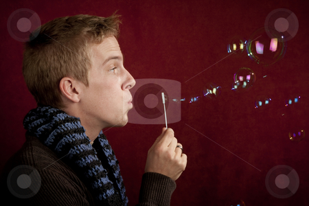 To use this stock image in your creative project, please select the size you need over to the right and click the "Add to Cart" button.
Your downloaded image will come with the Cutcaster watermark removed so don’t worry about the watermark you see on this page. Young Man Blowing a Bubbles stock photo, Handsome young blonde man blowing a bubbles by Scott Griessel