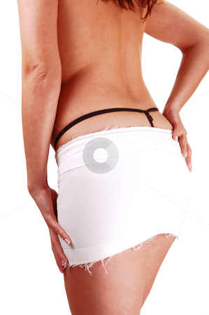 To use this stock image in your creative project, please select the size you need over to the right and click the "Add to Cart" button.
Your downloaded image will come with the Cutcaster watermark removed so don’t worry about the watermark you see on this page. Young woman in mini skirt only. stock photo, A young woman shooing her back in a white mini skirt an black thong
and topless holding her hand on the hips. by Horst Petzold