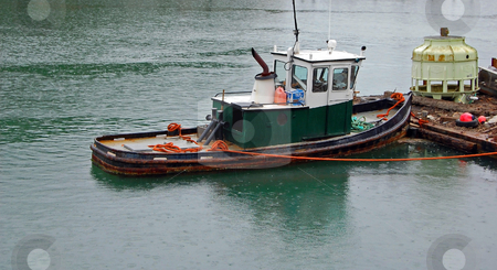 To use this stock image in your creative project, please select the size you need over to the right and click the "Add to Cart" button.
Your downloaded image will come with the Cutcaster watermark removed so don’t worry about the watermark you see on this page. Green Tug Boat Tied to Dock stock photo, A green tug boat is tied to a dock in the rain. by Valerie Garner