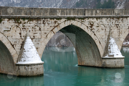 To use this stock image in your creative project, please select the size you need over to the right and click the "Add to Cart" button.
Your downloaded image will come with the Cutcaster watermark removed so don’t worry about the watermark you see on this page. Detail of Bridge on Drina stock photo, Detail of the bridge on the Drina in VIsegrad, Bosnia and Herzegovina on a winter overcast day. by Denis Radovanovic