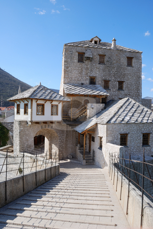 To use this stock image in your creative project, please select the size you need over to the right and click the "Add to Cart" button.
Your downloaded image will come with the Cutcaster watermark removed so don’t worry about the watermark you see on this page. Tower with Gate in Mostar Old Town stock photo, View from the Old Bridge of the west tower and gate in Mostar old town on a sunny day. by Denis Radovanovic