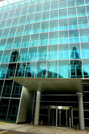 To use this stock image in your creative project, please select the size you need over to the right and click the "Add to Cart" button.
Your downloaded image will come with the Cutcaster watermark removed so don’t worry about the watermark you see on this page. Front Door stock photo, The deserted front door of a large commercial office block, surrounded by trees reflected in the glass. One tree reflection appears to grow out of a pillar of the entrance. Also, contrast between light at top of building and dark inside door. by Alistair Scott