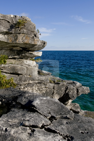 To use this stock image in your creative project, please select the size you need over to the right and click the "Add to Cart" button.
Your downloaded image will come with the Cutcaster watermark removed so don’t worry about the watermark you see on this page. Natures stepping stones stock photo, Focus on rock formations in the foreground, and deep blue water of Georgian Bay in the background. by Kevin Woodrow