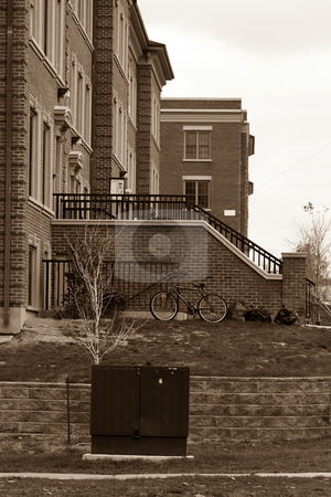 To use this stock image in your creative project, please select the size you need over to the right and click the "Add to Cart" button.
Your downloaded image will come with the Cutcaster watermark removed so don’t worry about the watermark you see on this page. University residences stock photo, A university residence complex, in black and white, with a bike and garbage bags in the foreground. by Kevin Woodrow