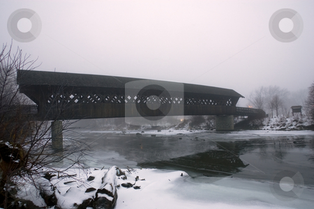 To use this stock image in your creative project, please select the size you need over to the right and click the "Add to Cart" button.
Your downloaded image will come with the Cutcaster watermark removed so don’t worry about the watermark you see on this page. Covered Bridge in Winter stock photo, A covered walking bridge taken in winter, on an overcast early evening. by Kevin Woodrow