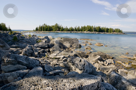 To use this stock image in your creative project, please select the size you need over to the right and click the "Add to Cart" button.
Your downloaded image will come with the Cutcaster watermark removed so don’t worry about the watermark you see on this page. Rocky Beach with Island View stock photo, A rocky beach, clear water, clear day, and view of a small island in the distance. by Kevin Woodrow