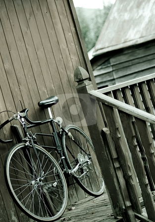 To use this stock image in your creative project, please select the size you need over to the right and click the "Add to Cart" button.
Your downloaded image will come with the Cutcaster watermark removed so don’t worry about the watermark you see on this page. Bicycle at rest stock photo, A bicycle resting up against the side of a house. by Kevin Woodrow