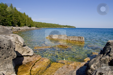 To use this stock image in your creative project, please select the size you need over to the right and click the "Add to Cart" button.
Your downloaded image will come with the Cutcaster watermark removed so don’t worry about the watermark you see on this page. Rocky Cove stock photo, Tranquil water in a Rocky Cove on a Clear day, with sharp focus on the rock textures. by Kevin Woodrow